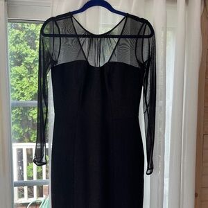 Long Sleeve black sheath knit evening dress with sheer neckline.